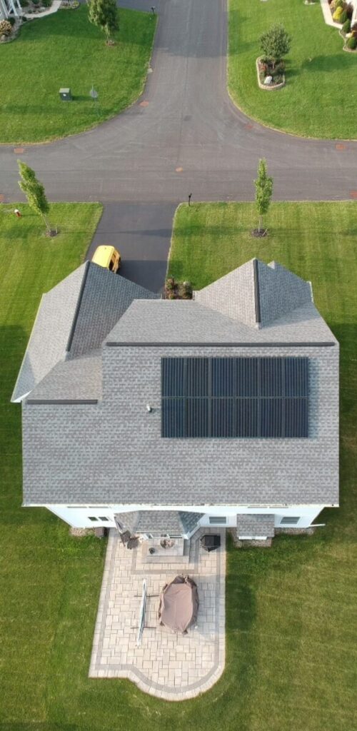 Drone view of residential home with solar on roof